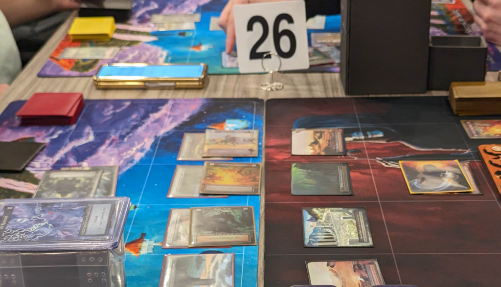 Sorcery cards and playmats on a table